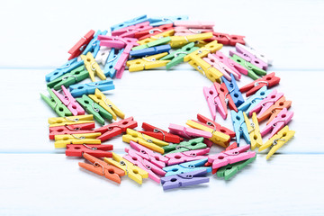 Colorful clothespins on wooden table