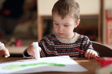 boy drawing with color pencils