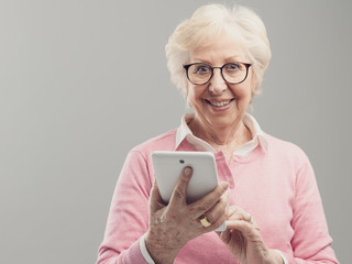 Happy senior lady using a digital tablet