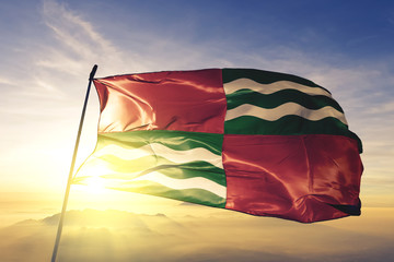 Quebradillas municipality of Puerto Rico flag waving on the top sunrise mist fog