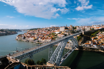 aerial view of porto portugal with dom luis bridge, douro river rabelos boats
