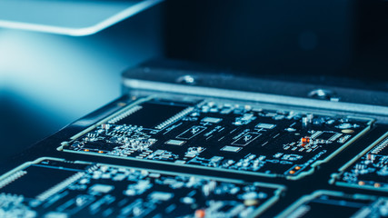 Close-up Macro Shot of Electronic Factory Machine at Work: Printed Circuit Board (PCB) Being...