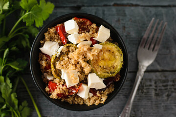 Baked vegetable salad with quinoa and Serbian cheese. Vegetarian dish. The view from the top. Flat lay.