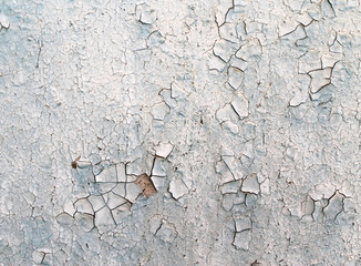 Old wooden background with remains of pieces of scraps of old paint on wood. Texture of an old tree, board with paint, vintage background peeling paint. 