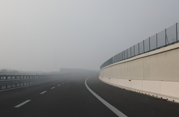 dense very dangerous fog near the curve of the highway