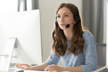Businesswoman in headset call center agent consulting participating video conference - Powered by Adobe
