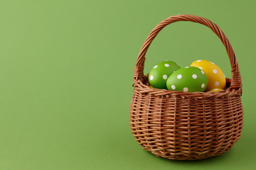 Wicker basket with painted Easter eggs