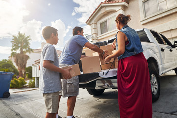 hispanic family unloading pickup truck and moving into new house in las vegas © Joshua Resnick