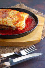 Francesinha - Portuguese sandwich with wet-cured ham, sausage, roast meat, and covered with melted cheese