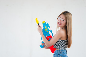 Asian sexy woman with gun water in hand on white background,Festival songkran day at thailand,The best of festival of thai,Land of  smile