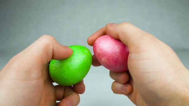 Man ready to play a traditional Easter game Egg tapping or dumping competition with coloured dyed eggs during Christian holiday Pascha or Resurrection Sunday