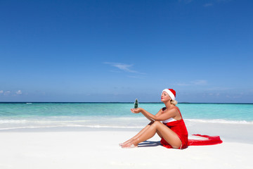 woman in Santa costume on beach