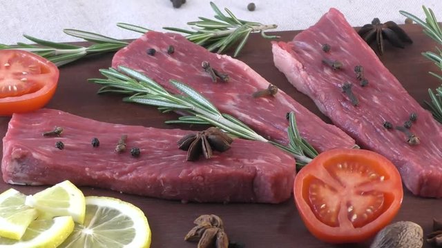 Marbled beef meat on the cutting board with rosemary