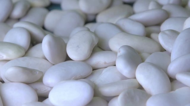 Close-up white beans on the wooden table, ready to cooking