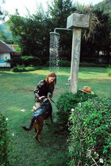 Asian woman washing her pet dog