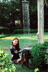 Asian woman washing her pet dog