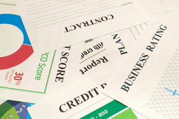 Credit score, report, rating and contract on the table.