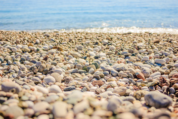 Mediterranean landscape in Antalya, Turkey. Blue sea, waves and pebble sandy beach