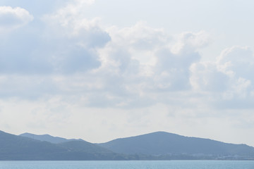 The nature of blue sky with cloud, mountain and seascape background in the morning.