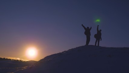 Man teamwork business travel silhouette concept. two hikers winter snow tourists climbers climb to the top of mountain lifestyle . overcoming hardships the path to victory, teamwork, important points.