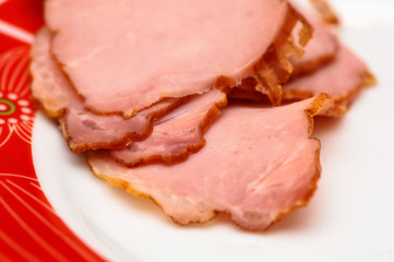 Plate with tasty sliced baked ham on table