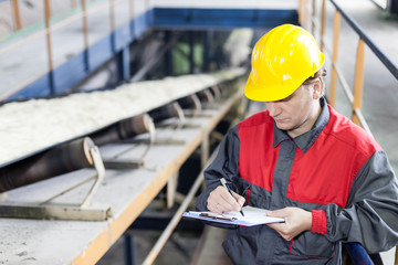 Transport of sugar on the production line , worker writes on the paper © Avatar_023