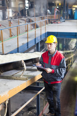 Fototapeta premium Transport of sugar on the production line , worker writes the quality information