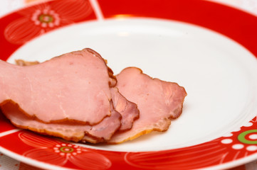 Plate with tasty sliced baked ham on table