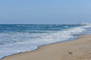 Sea, Blue waves with white foam, under the blue sky.
