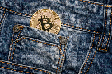 Bitcoin cryptocurrency in the pocket of jeans. Concept with bitcoin.