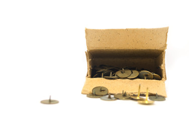 the macro photo of pushpins. The sharp nail head rests on the white floor to wait to be used.