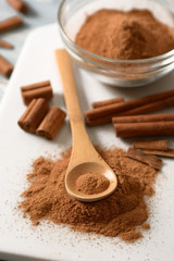 cinnamon powder on white cutting board