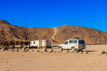 Off road SUV car in bedouin village in Arabian desert near Hurghada, Egypt