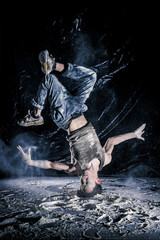 cool dirty vietnamese  guy dancer in style of bboying doing complex tricks on floor in Studio...