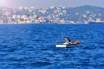 Fisherman on a small boat in the sea