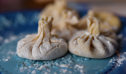 dumplings khinkali boiled on a blue plate