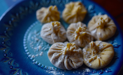 dumplings khinkali boiled on a blue plate