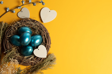 colorful vintage blue easter eggs festival seasoning with yellow background with heart wood...