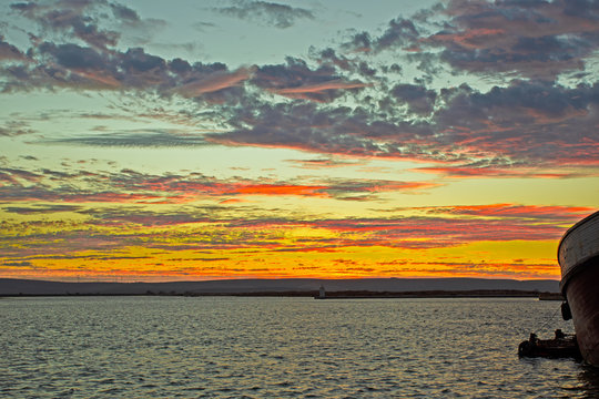 Multicoloured sunset in fishing harbour