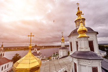 Fototapeta premium Eastern orthodox crosses on gold domes, cupolas, against blue sky with clouds