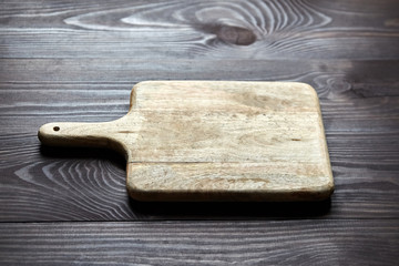 Cutting board on brown wooden table