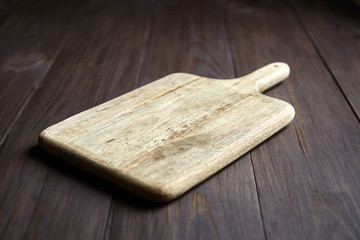 Cutting board on brown wooden table