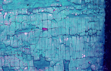 Fototapeta na wymiar Old wooden background with remains of pieces of scraps of old paint on wood. Texture of an old tree, board with paint, vintage background peeling paint.
