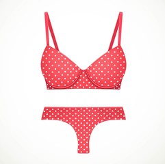 Red bra and thong panties in a white polka dot pattern objects isolated on white background