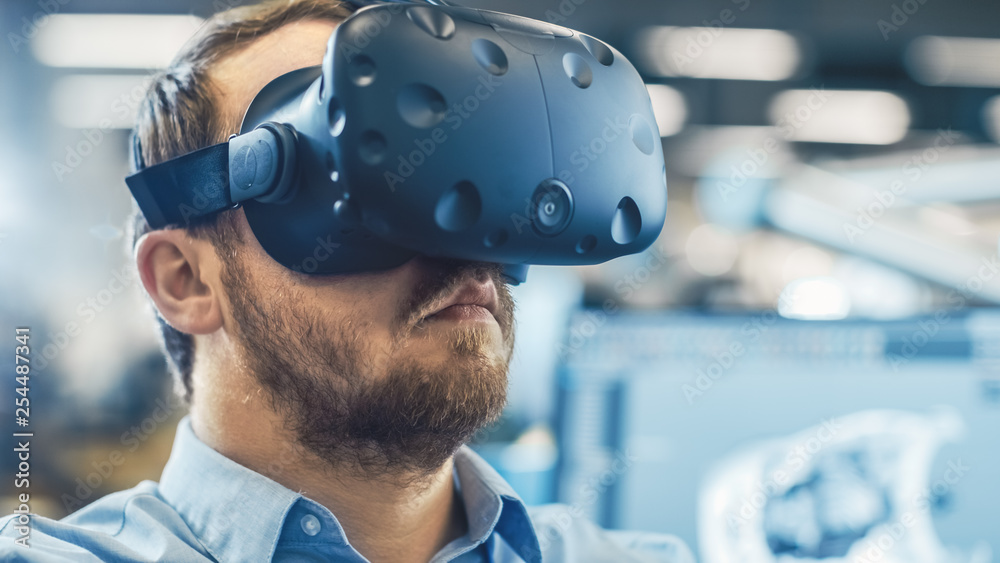 Aufkleber portrait shot of the industrial engineer wearing virtual reality headset and gesturing with controll
