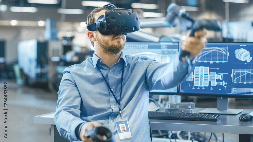 Poster portrait shot of the industrial engineer wearing virtual reality headset and using controllers, read