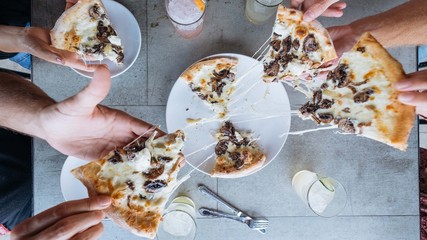 Pizza slices being pulled on table