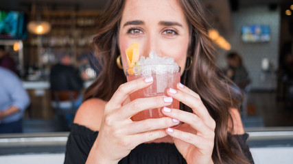 Young woman holding cocktail