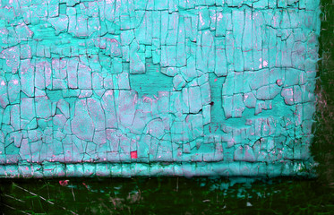 Old wooden background with remains of pieces of scraps of old paint on wood. Texture of an old tree, board with paint, vintage background peeling paint.