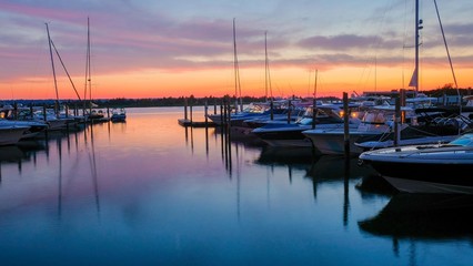 Fototapeta na wymiar Boats on Harbor at Sunset